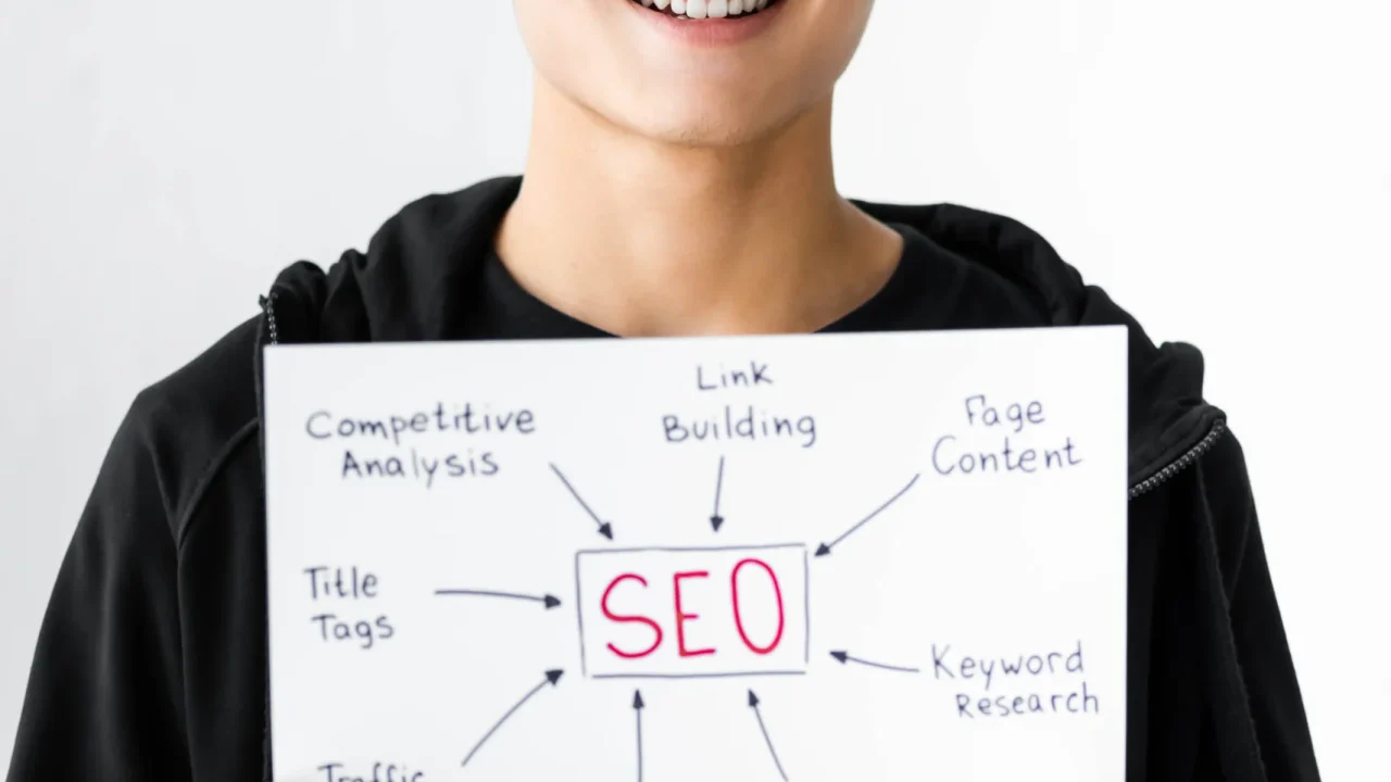 smiling-asian-seo-manager-holding-paper-with-conce-2024-11-07-16-34-17-utc